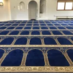 A blue prayer rug with intricate golden patterns