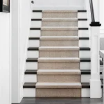 Custom-fit stair carpet with floral designs in a Dubai residence.