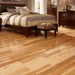 Distressed pine solid wood flooring in a vintage-themed bedroom.
