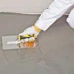 A professional installing a self leveling floor in Dubai