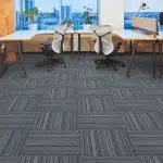 Office space with patterned grey carpet and city view.