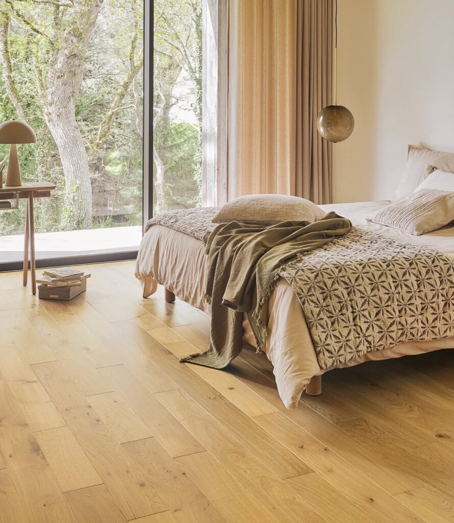 Bright bedroom with wide plank oak engineered wood flooring