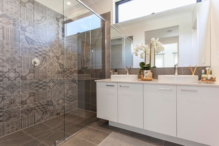 stylish-bathroom-remodel-with-patterned-encaustic-shower-tiles-glass-shower-enclosure-double-white-vanity-unit-and-twin-vessel-basins