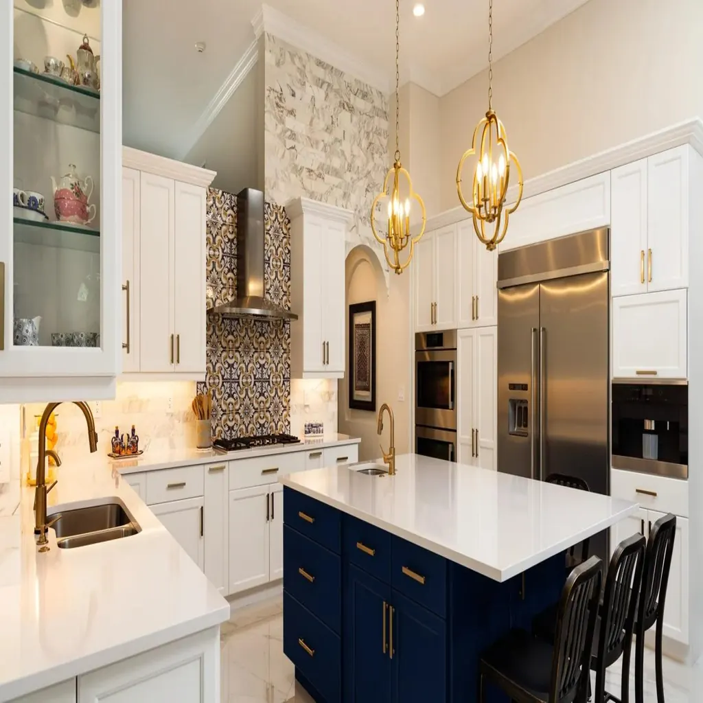 Luxury white kitchen with navy island gold chandeliers and mosaic backsplash